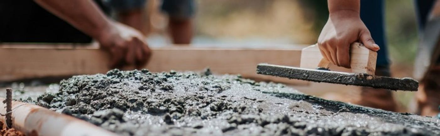 Image of construction workers levelling concrete