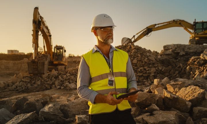 Image of a civil engineer on a construction site using a tablet