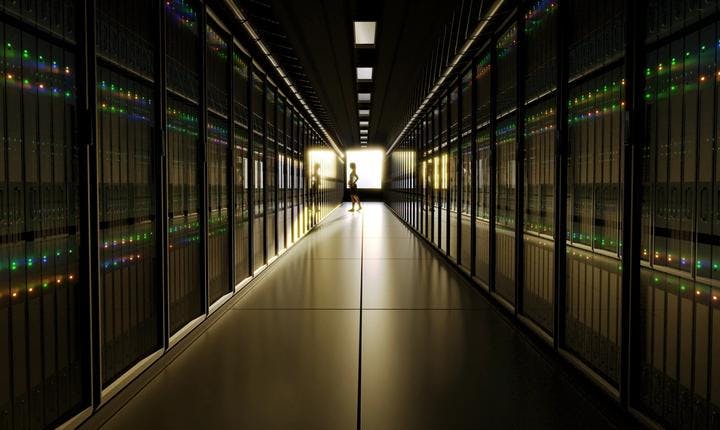 Image of a massive data centre, with banks of servers